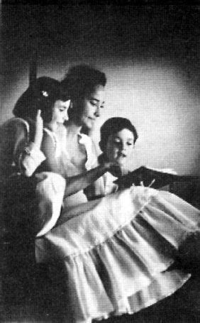 Merle reading to her adopted children Francesca and Bruno whom she adopted with her 3rd husband ...