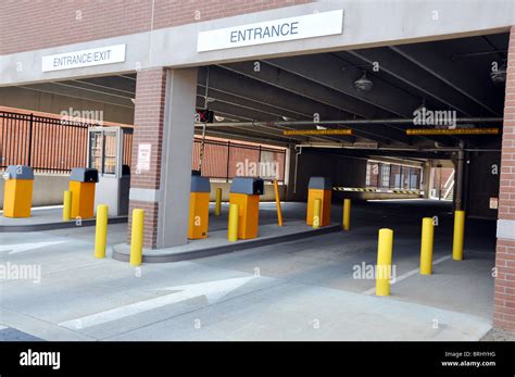 Parking deck entrance and exit with booth Stock Photo - Alamy