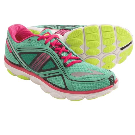 a pair of green and pink running shoes