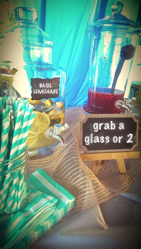 Drink station with glass apothecary beverage dispensers and chalkboard labels. Station includes ...