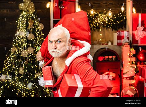 Dangerous burglar dressed in Santa costume. Santa in the mask with bag. Funny Santas with bags ...