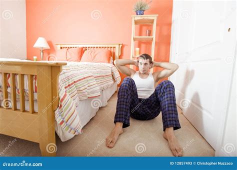 Man Doing Sit-Ups In Bedroom Stock Image - Image: 12857493