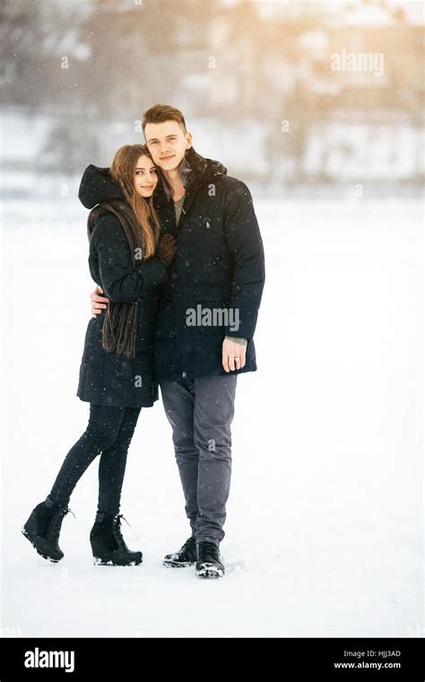 couple posing in a snowy park Stock Photo - Alamy