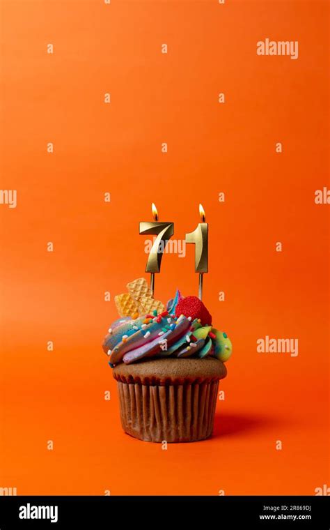 birthday cake with number 71 - cupcake on orange background with birthday candles Stock Photo ...