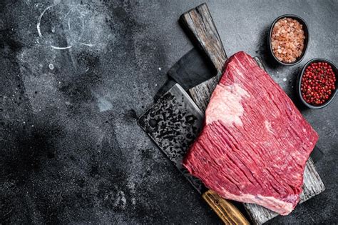 Premium Photo | Uncooked Raw beef brisket meat on butcher board Black background Top view Copy space