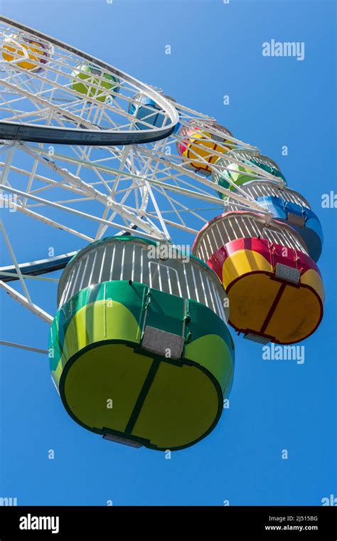 Looking up at colourful ferris wheel carts Stock Photo - Alamy