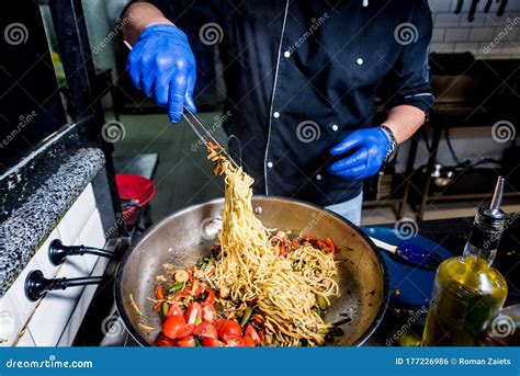 Chef Cooking Pasta with Vegetables in Pan. Italian Style Cuisine ...