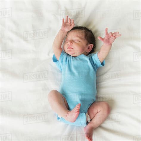 Portrait of newborn baby boy (0-1 months) sleeping - Stock Photo - Dissolve