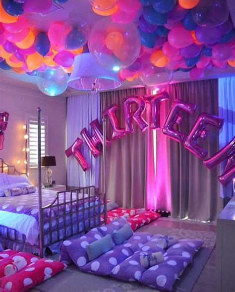 a bedroom decorated with balloons and bedding