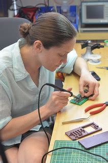 Dena doing repairs on her phone | David Mellis | Flickr