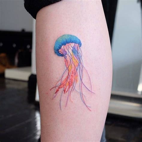 a colorful jellyfish tattoo on the right thigh