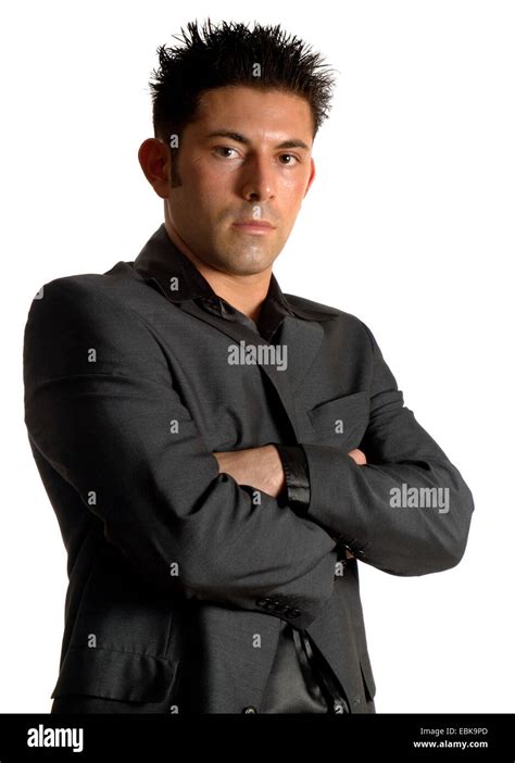 young man in dark-gray suit wiht crossed arms Stock Photo - Alamy