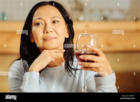 Delighted woman drinking red wine Stock Photo - Alamy