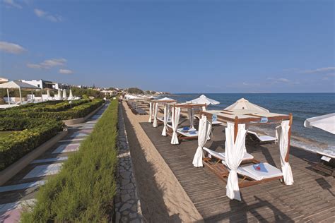 Aldemar Knossos Royal Beach Hotel is bathed in sunlight, calmed by the gentle waves of the ...