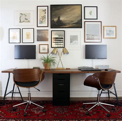 Two-person IKEA desk with Lerberg trestle legs and Karlby countertop. Wall-mounted monitors ...