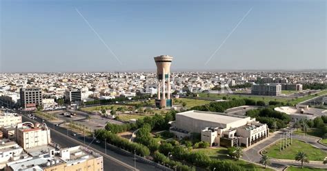 Tabuk Tower in the city of Tabuk, Saudi Arabia, trees and green plants, roads and streets ...