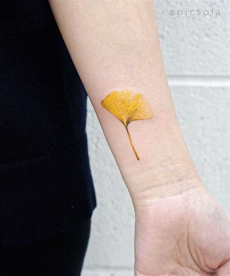 Yellow ginkgo leaf tattoo by tattooist picsola - Tattoogrid.net