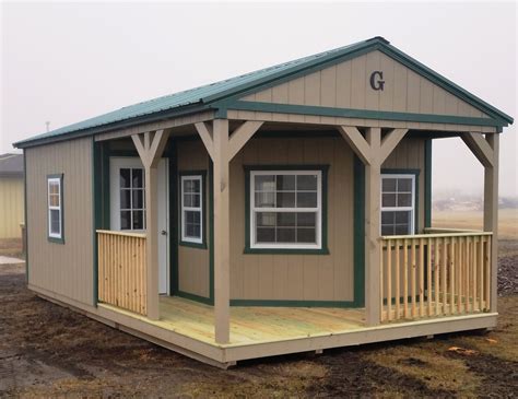 14x24 Cabin with L-shaped Porch and railings. Green Metal Roof with Matching Trim. LP Smartside ...