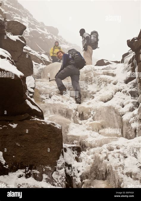 Climbing a frozen waterfall in Crowden brook on Kinder Scout in the ...