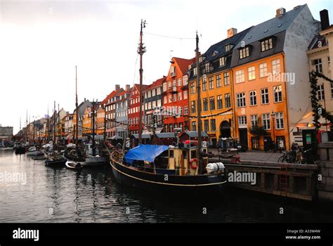 Colourful houses and wooden sailing ships and boats Nyhavn Copenhagen ...