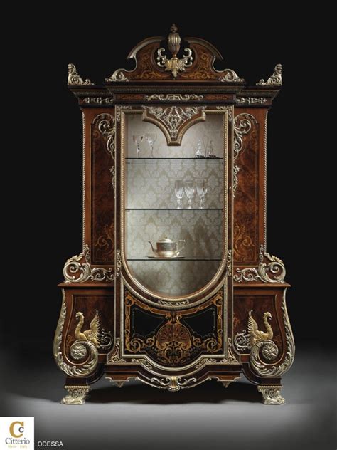 an ornate wooden display cabinet with glass doors