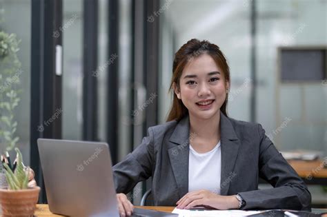 Premium Photo | Happy young asian businesswoman working on laptop keyboard with document at ...