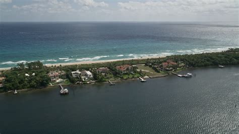 5K stock footage aerial video of a row of lakeside mansions with docks in Manalapan, Florida ...