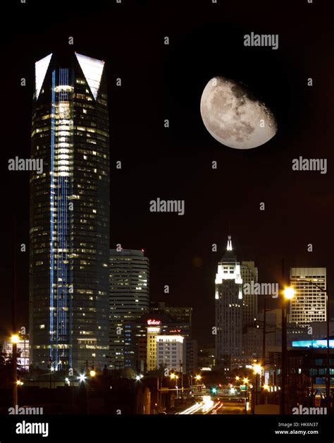 A view of downtown Oklahoma City at night with the moon above the city ...