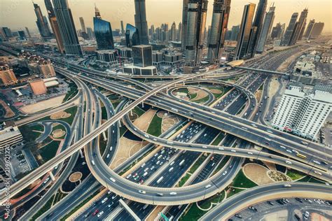 Aerial view of a big highway intersection in Dubai, UAE, at sunset. Transportation and ...