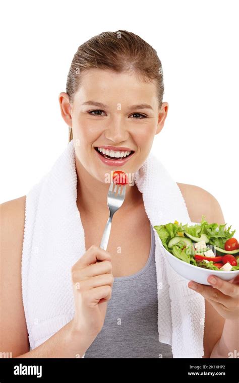 Eating green to stay lean. Head and shoulder shot of a healthy teenage girl enjoying a salad ...