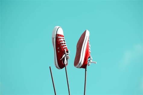 Download Red Converse Shoes Against Iron Bars Wallpaper | Wallpapers.com