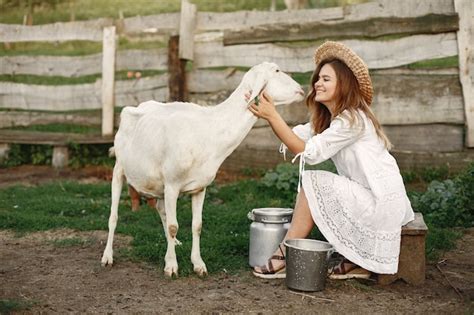 Free Photo | Girl farmer with white goat. woman and small goat green grass. eco farm. farm and ...