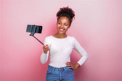 Young girl holding mobile phone takes a picture selfie - Image 3492018 Stock Photo at Vecteezy