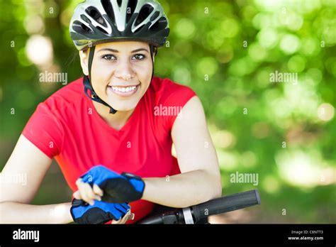 Hispanic woman riding mountain bike Stock Photo - Alamy