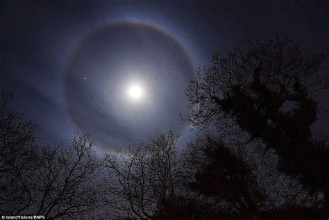 Halo formed around the moon as light bent by ice crystals in the atmosphere | Daily Mail Online