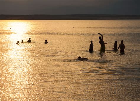 FREE IMAGE: Silhouette Of Young People Playing In The Sea In Sunset | Libreshot Public Domain Photos
