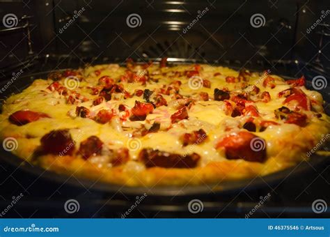 Pizza baking in oven stock photo. Image of delicious - 46375546