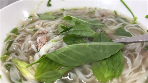 PHO BO Vietnamese Noodle Soup in Bowl. Making Asian Soup Street Food. Man Eating Fast Food with ...