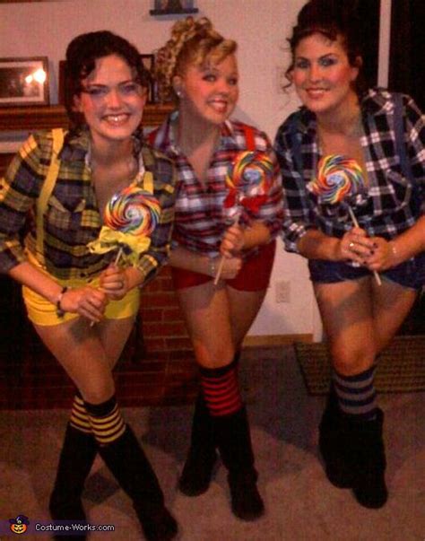 three women dressed in costumes holding lollipops and candy canes ...