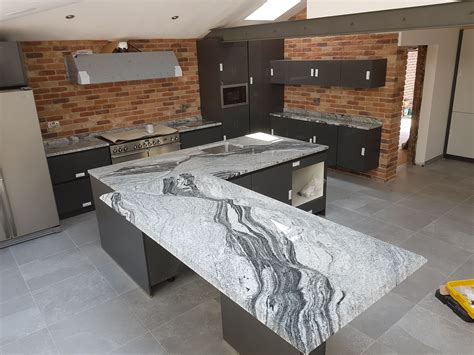 Beautiful viscount white granite worktop fitted by Impala Stone Ltd in an open plan living space ...