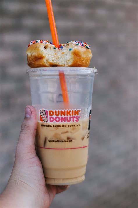 dunkin' donuts' on top of iced coffee cup and orange straw free image | Peakpx