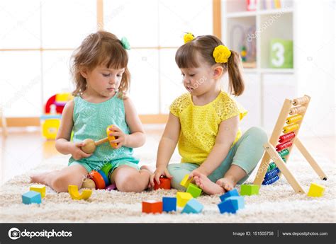 Children playing together with building blocks. Educational toys for preschool and kindergarten ...