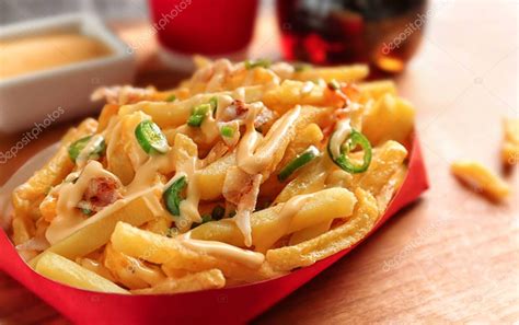 French fries with cheese sauce — Stock Photo © belchonock #147556213