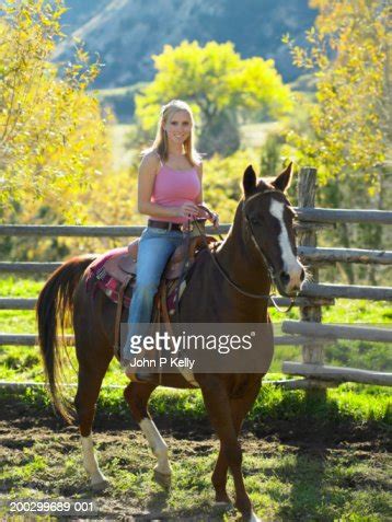 Young Woman Sitting On Horse Smiling Portrait High-Res Stock Photo - Getty Images