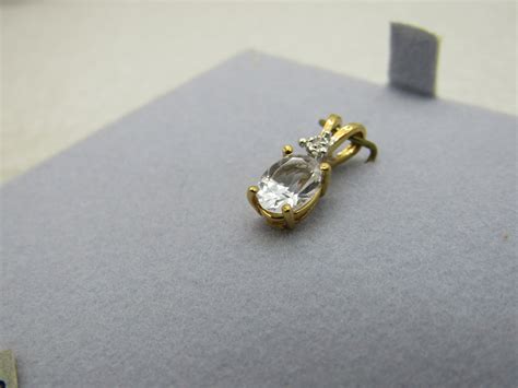 14kt White Zircon Birthstone Pendant, Diamond Chip. 1.2CTW