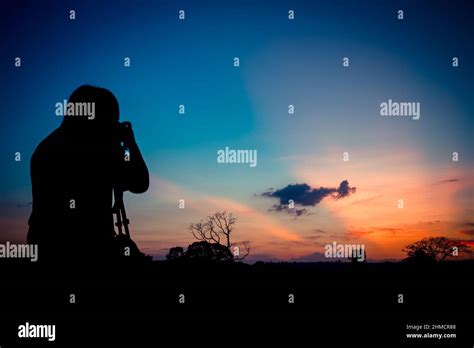 Silhouette photographer with sunset background Stock Photo - Alamy