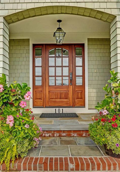 Green home with cedar shake siding and a stained wood front door | Stained front door, Green ...