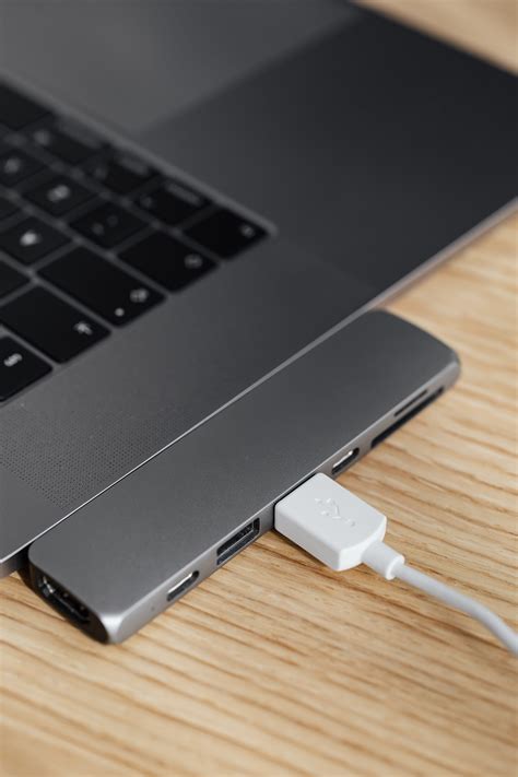 Laptop and usb port multiplier with connected cable · Free Stock Photo