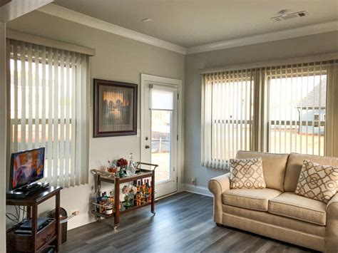 Stylish Vertical Blinds In A Warm Living Room Featuring Beige Accents Custom Drapes, Custom ...