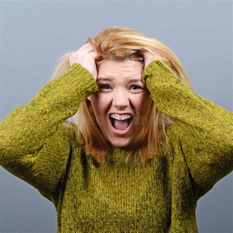 Portrait of a Hysterical Woman Pulling Hair Out Against Gray Background Stock Image - Image of ...